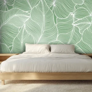Toile tendue murale Feuilles tropicales surdimensionnées, posée dans un intérieur